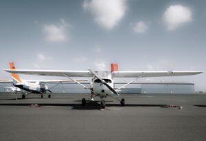 "A luxurious private jet parked on the runway after landing on land, with a blue sky in the background. The image represents one of the common Things Rich People Buy, as private jets are often associated with luxury and exclusivity.