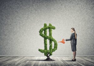 A woman watering a plant in the shape of a dollar sign, representing membership and subscription services for financial success.