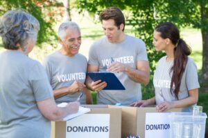 Things Rich People Buy" - Image of philanthropy in action with a group of dedicated volunteers working together to make a positive impact in their community.